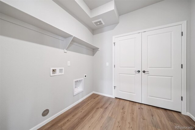 22384 E 49th Pl, Aurora, CO 80019 - washroom with washer hookup, hookup for an electric dryer, and light wood finished floors