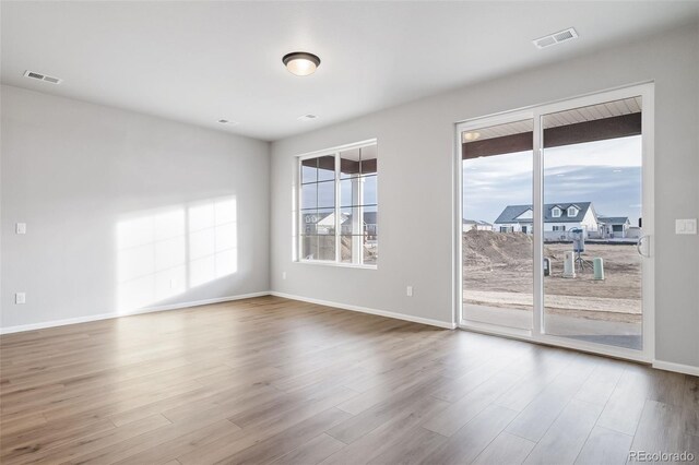 22384 E 49th Pl, Aurora, CO 80019 - spare room featuring wood finished floors and baseboards
