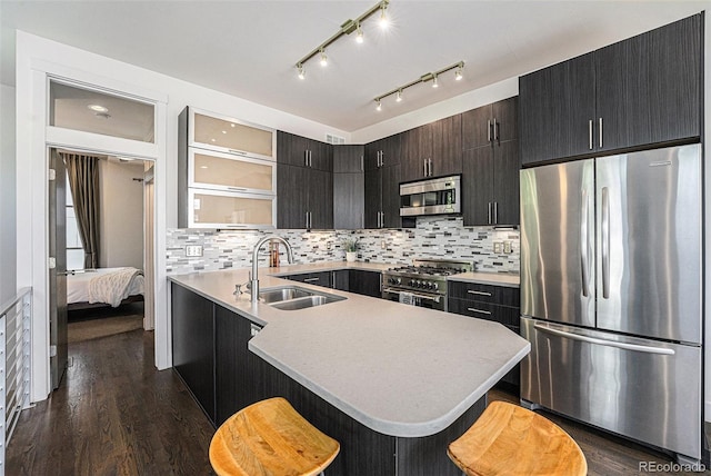 2103 W 32nd Ave Unit 10, Denver, CO 80211 - kitchen with stainless steel appliances, light countertops, a kitchen breakfast bar, and dark wood-style flooring