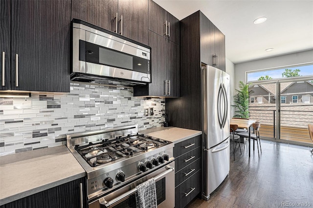 2103 W 32nd Ave Unit 10, Denver, CO 80211 - kitchen featuring appliances with stainless steel finishes, light countertops, tasteful backsplash, dark wood finished floors, and recessed lighting