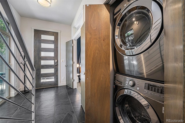 2103 W 32nd Ave Unit 10, Denver, CO 80211 - laundry area with stacked washer and clothes dryer and baseboards