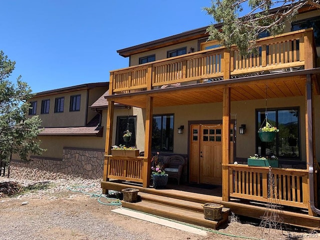 rear view of property with a balcony