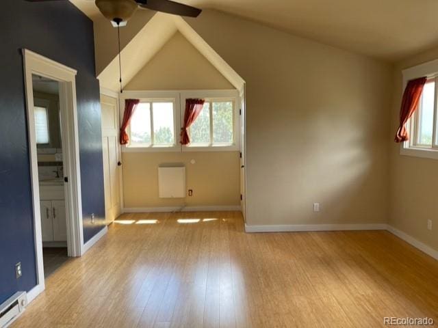 bonus room featuring high vaulted ceiling, baseboard heating, ceiling fan, and light hardwood / wood-style flooring