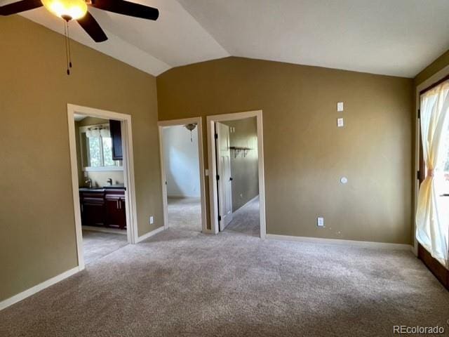 carpeted empty room featuring ceiling fan and vaulted ceiling