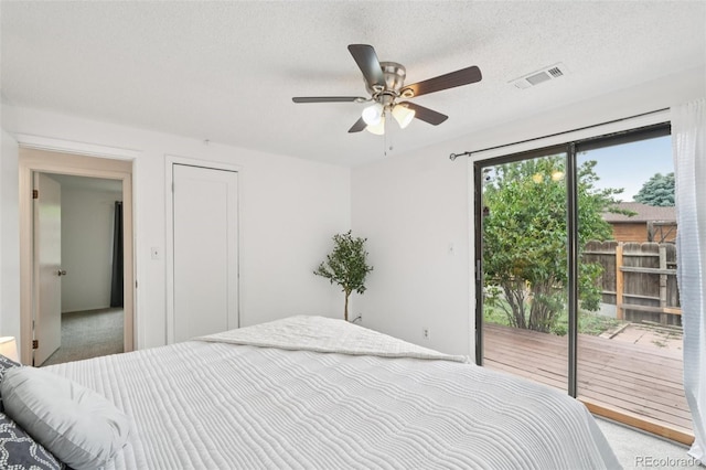 2393 E 90th Ave, Thornton, CO 80229 - carpeted bedroom featuring access to outside, a textured ceiling, and ceiling fan