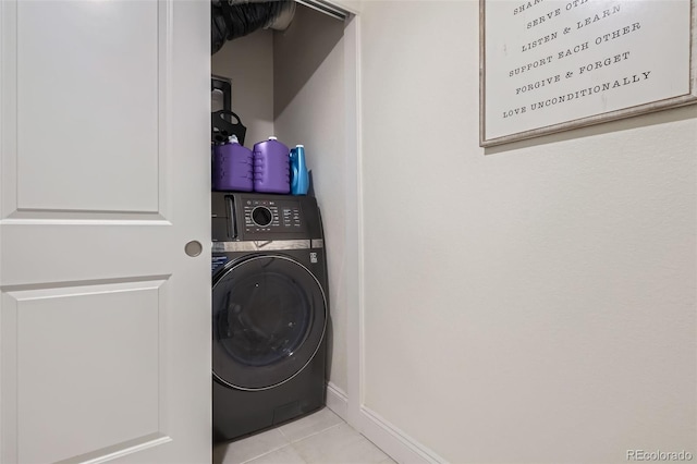 16841 Askins Loop Unit 105, Parker, CO 80134 - washroom featuring washer / clothes dryer, tile patterned flooring, and baseboards