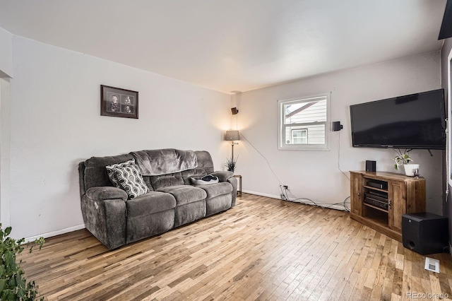 1254 S Osceola St, Denver, CO 80219 - living area with baseboards, visible vents, and light wood-style floors