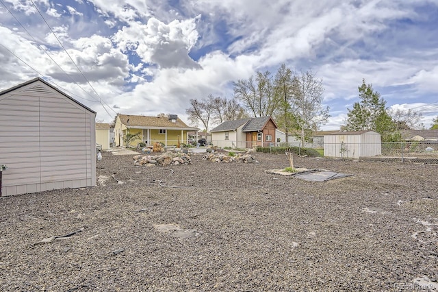1254 S Osceola St, Denver, CO 80219 - view of yard featuring fence, an outbuilding, and a shed