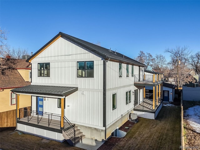 rear view of property featuring a balcony