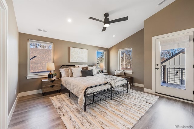 bedroom featuring ceiling fan, hardwood / wood-style floors, access to outside, and lofted ceiling