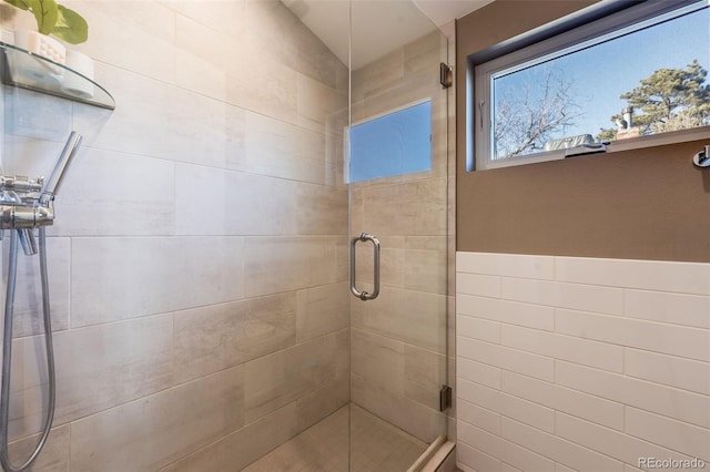 bathroom featuring a shower with door