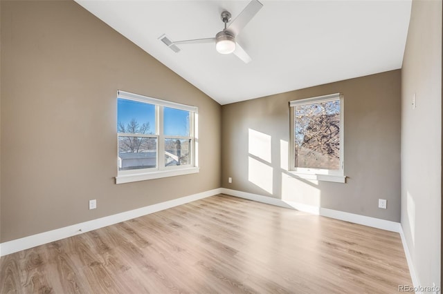 empty room featuring light wood-type flooring, vaulted ceiling, and ceiling fan