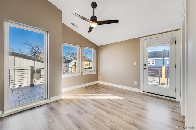 doorway to outside featuring light wood-type flooring, ceiling fan, plenty of natural light, and lofted ceiling