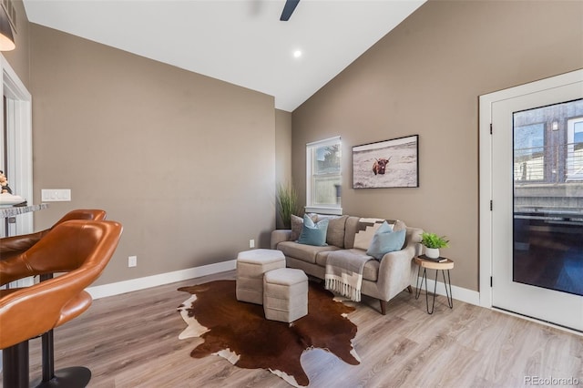 sitting room featuring light wood-type flooring, high vaulted ceiling, and plenty of natural light