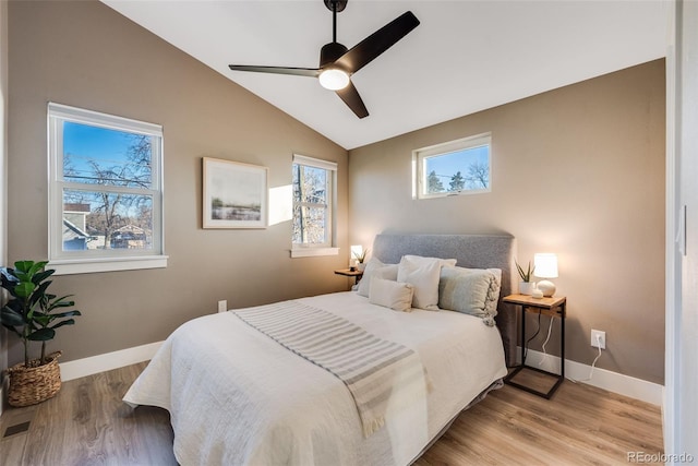 bedroom featuring light wood-type flooring, ceiling fan, and vaulted ceiling