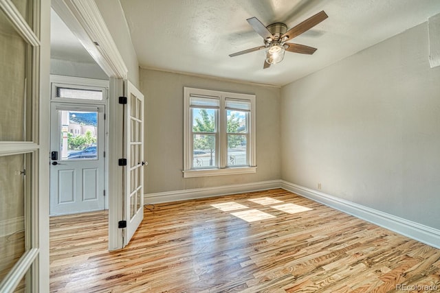 144 N C St, Salida, CO 81201 - entrance foyer featuring light wood finished floors, baseboards, ceiling fan, french doors, and a textured ceiling