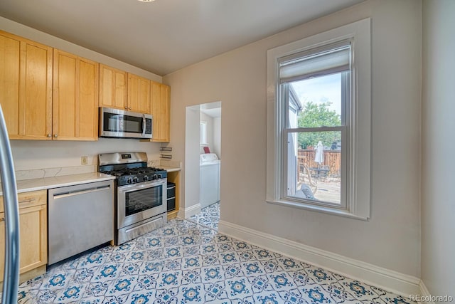 144 N C St, Salida, CO 81201 - kitchen with stainless steel appliances, washer / clothes dryer, light countertops, light brown cabinets, and baseboards