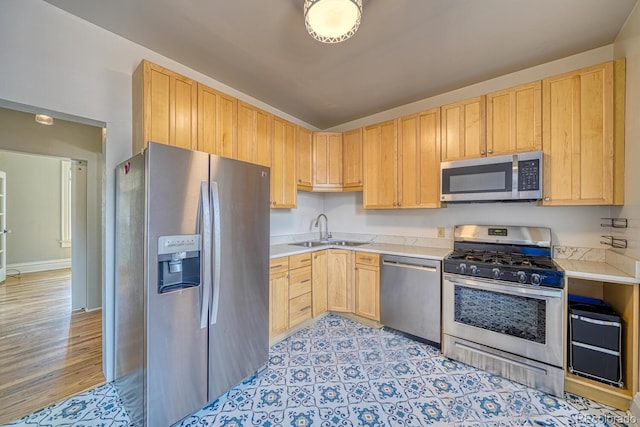 144 N C St, Salida, CO 81201 - kitchen with appliances with stainless steel finishes, a sink, light brown cabinets, and light countertops