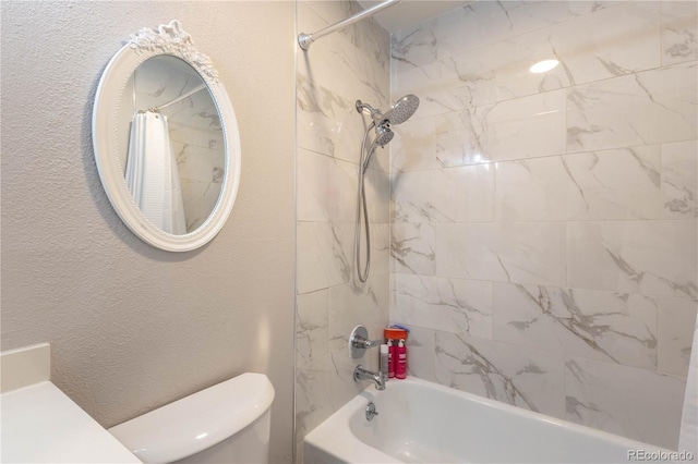 bathroom with shower / bath combo and toilet