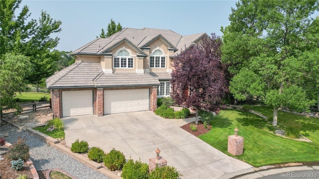 front of property with a garage and a front lawn