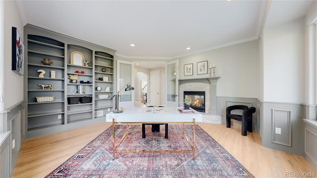 office featuring ornamental molding, built in features, and light wood-type flooring