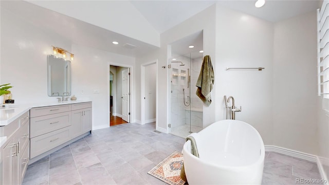 bathroom featuring vanity, lofted ceiling, and shower with separate bathtub