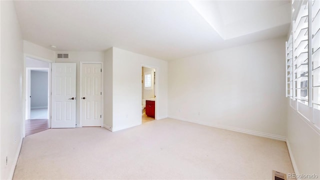 empty room featuring light colored carpet