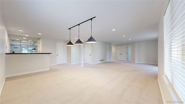 unfurnished living room with light carpet