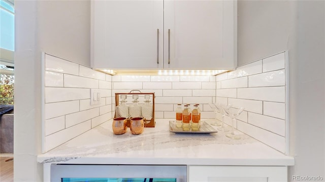 details featuring tasteful backsplash and wine cooler