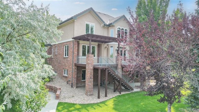 back of property featuring a yard, a pergola, a deck, and a patio area