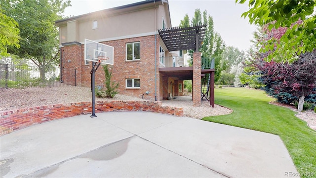 view of basketball court with a yard and a pergola