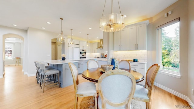 dining space with a healthy amount of sunlight and light hardwood / wood-style flooring