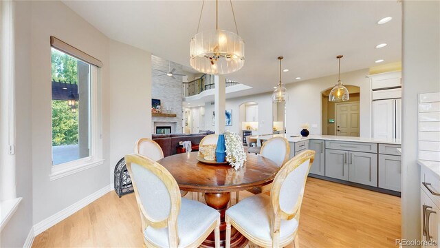 dining room with ceiling fan and light wood-type flooring