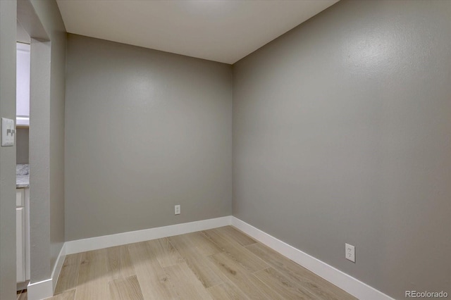 empty room with light wood-style flooring and baseboards