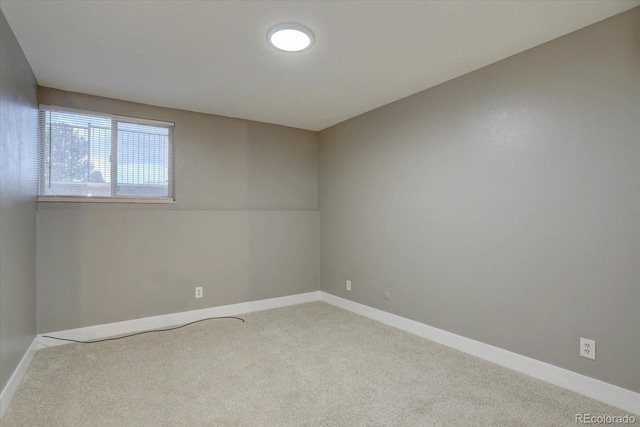 unfurnished room with carpet floors and baseboards