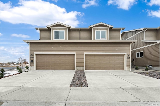 view of front of property with a garage and concrete driveway