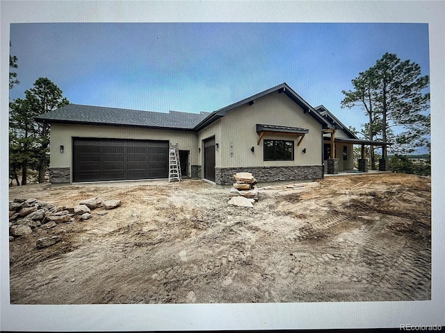 view of front of home with a garage and central AC