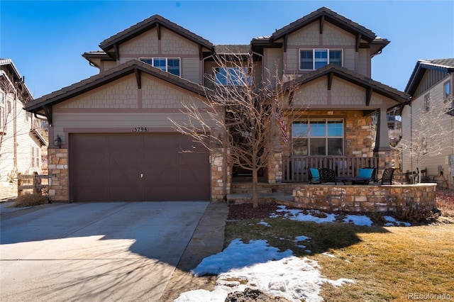 craftsman inspired home featuring covered porch, stone siding, concrete driveway, and an attached garage