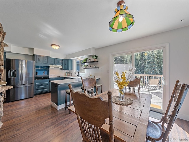 dining space with dark wood finished floors