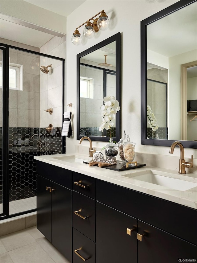 bathroom featuring walk in shower, tile patterned flooring, and vanity