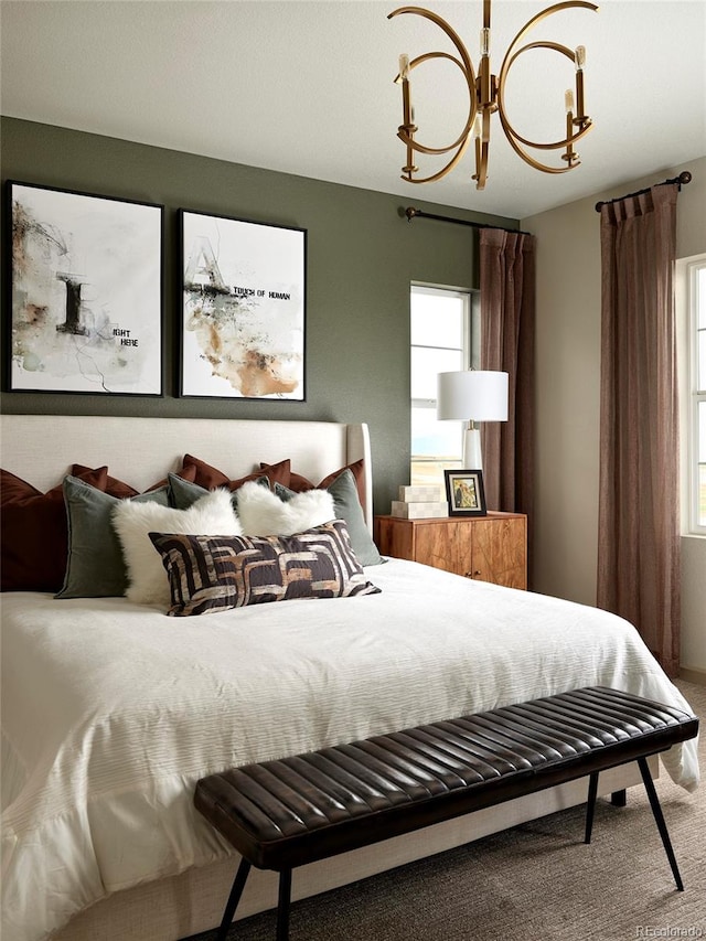 bedroom with carpet flooring and a notable chandelier