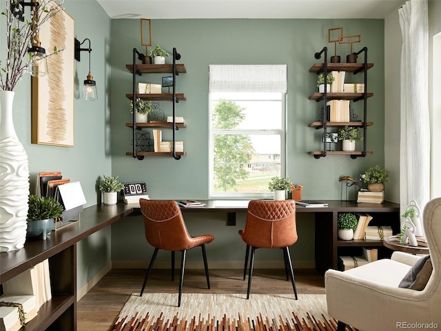 bar with hardwood / wood-style flooring and built in desk