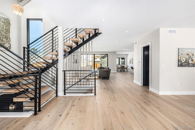 interior space featuring hardwood / wood-style floors, recessed lighting, visible vents, and baseboards