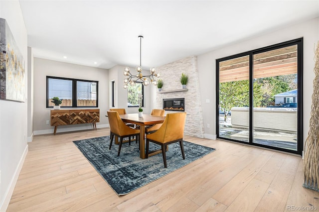 dining space featuring light wood-type flooring, baseboards, a chandelier, and recessed lighting