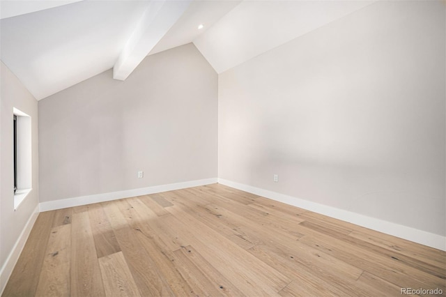 bonus room featuring baseboards, lofted ceiling with beams, and light wood finished floors