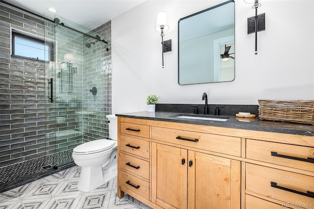 full bath with a stall shower, vanity, and toilet