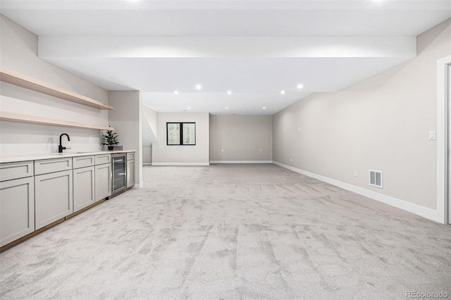 unfurnished living room with baseboards, visible vents, light colored carpet, and recessed lighting