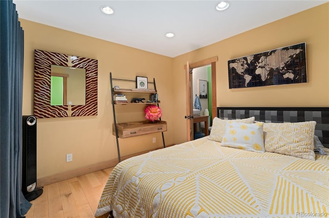 3313 Curtis St, Denver, CO 80205 - bedroom with wood finished floors, recessed lighting, and baseboards