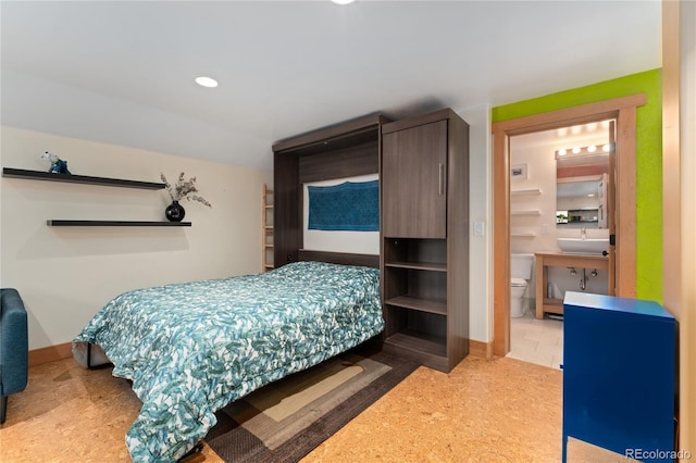 3313 Curtis St, Denver, CO 80205 - bedroom featuring a sink, ensuite bathroom, recessed lighting, and baseboards
