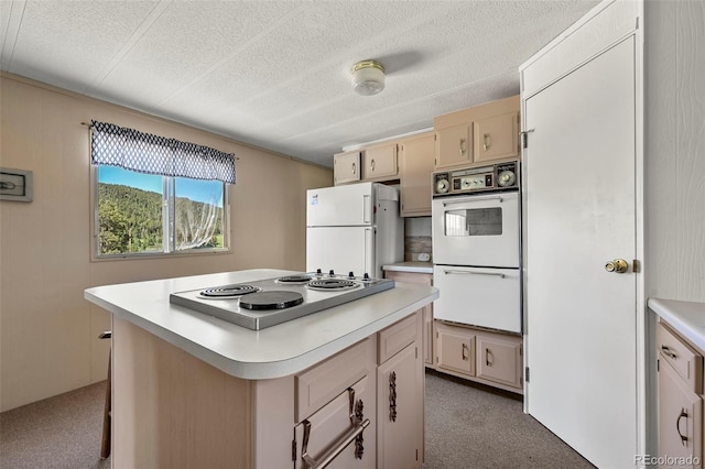 332 Valley Cir, Guffey, CO 80820 - kitchen featuring white appliances, light countertops, a kitchen island, a textured ceiling, and carpet flooring